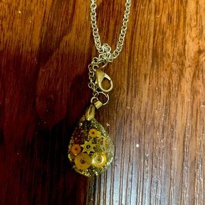 Stunning amber necklace piece with clock designs.